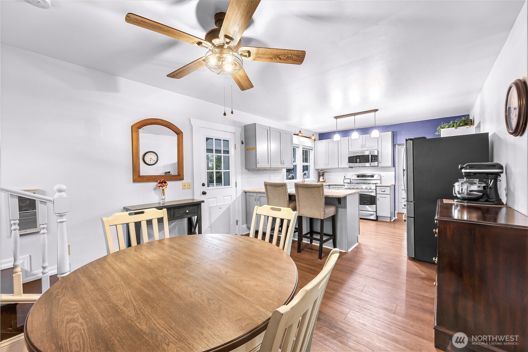 6981 Hannegan Road Lynden, WA 98264 - Photo 12 of 25 a living room with stainless steel appliances furniture a kitchen view and a dining table wooden floor