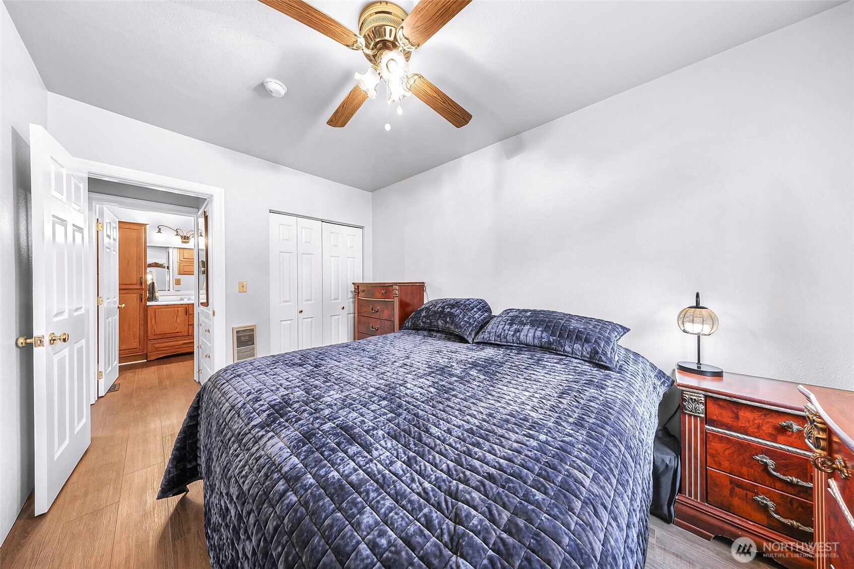6981 Hannegan Road Lynden, WA 98264 - Photo 15 of 25 a spacious bedroom with a bed and a chandelier