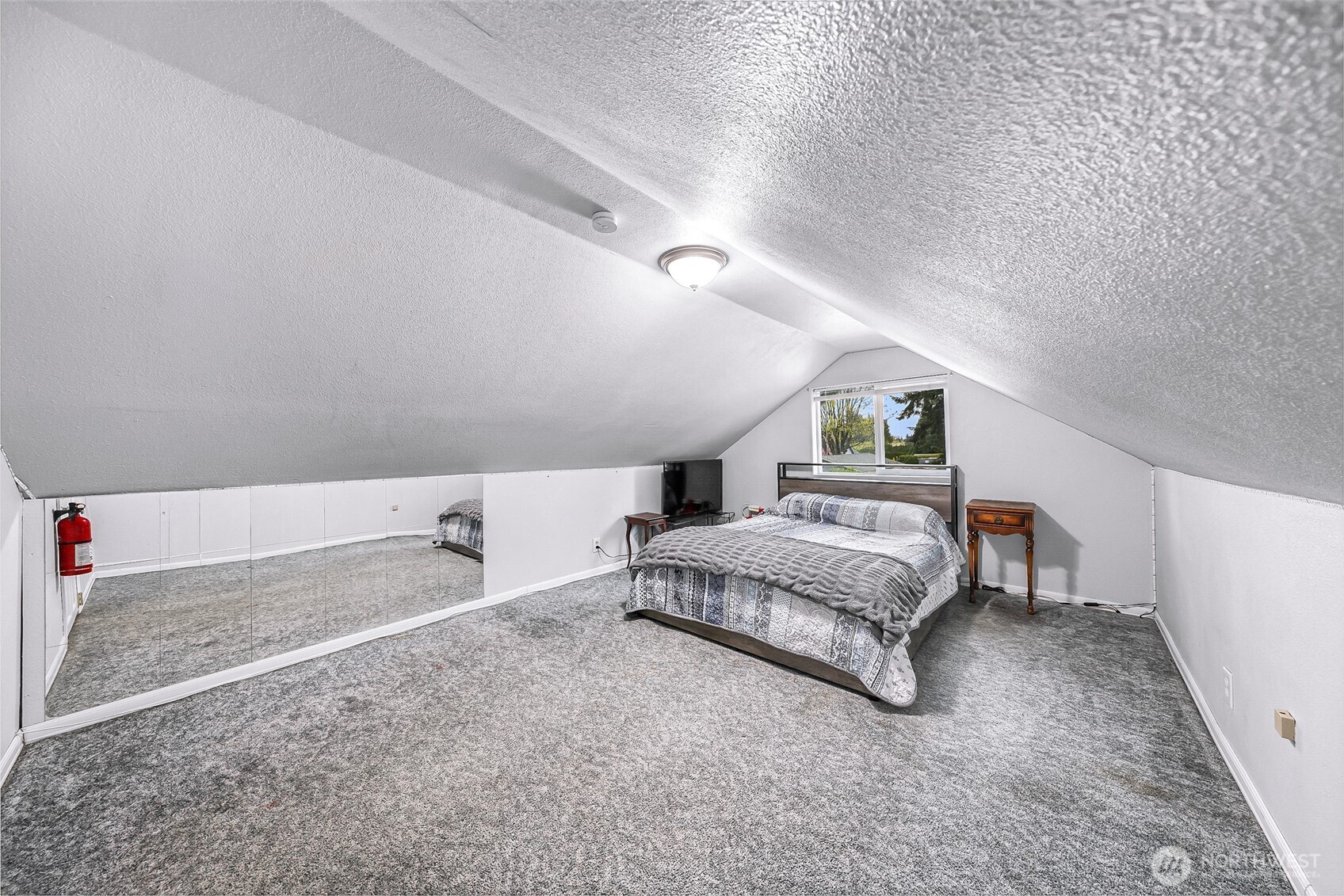 6981 Hannegan Road Lynden, WA 98264 - Photo 18 of 25 a spacious bedroom with a bed and a chandelier