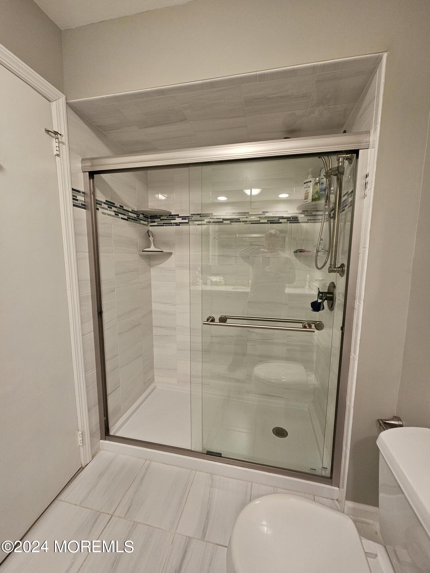 75 Overlook Way, Unit E Manalapan, NJ 07726 - Photo 11 of 12 a bathroom with a shower and toilet