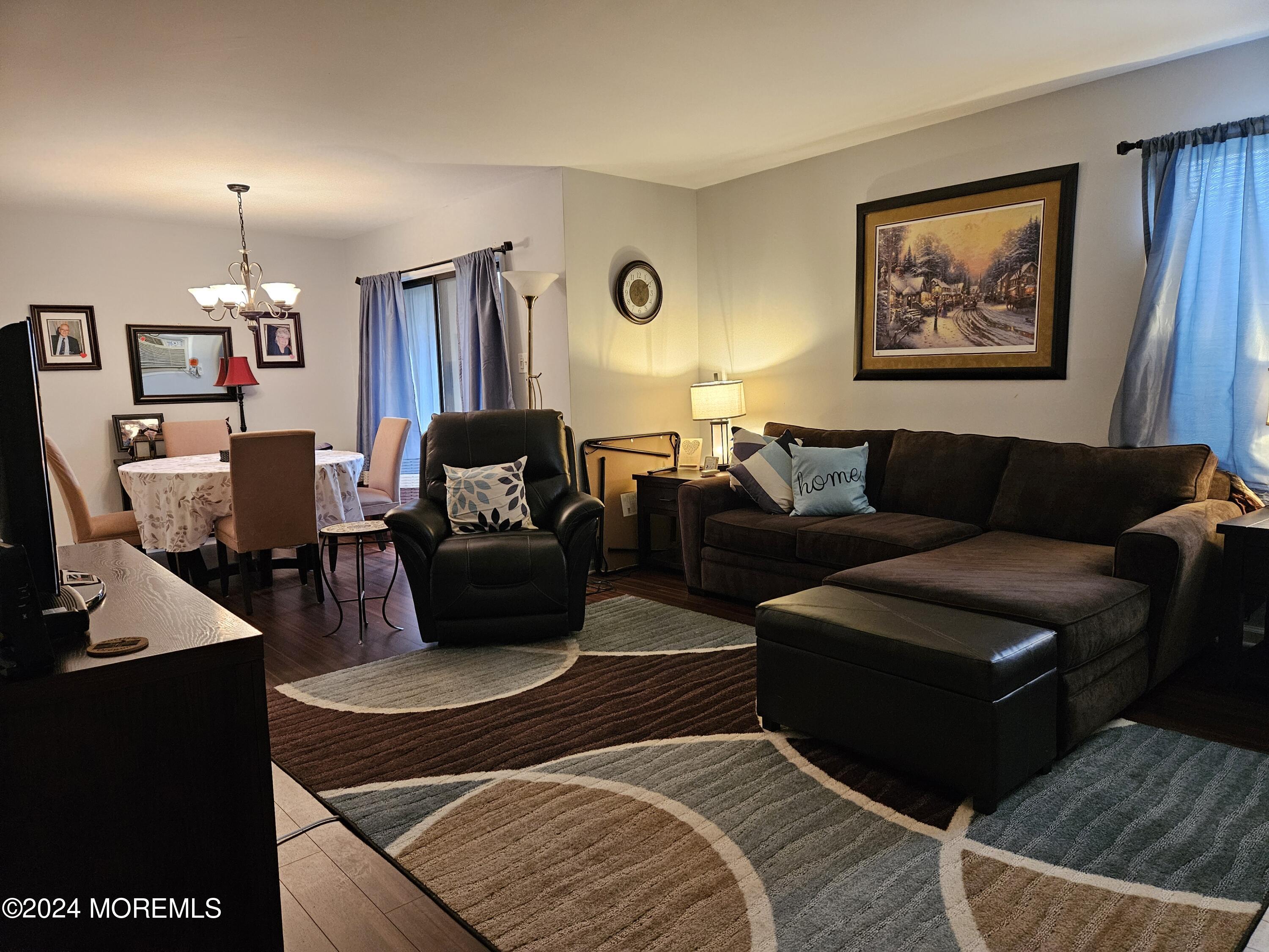 75 Overlook Way, Unit E Manalapan, NJ 07726 - Photo 2 of 12 a living room with furniture a lamp and a window