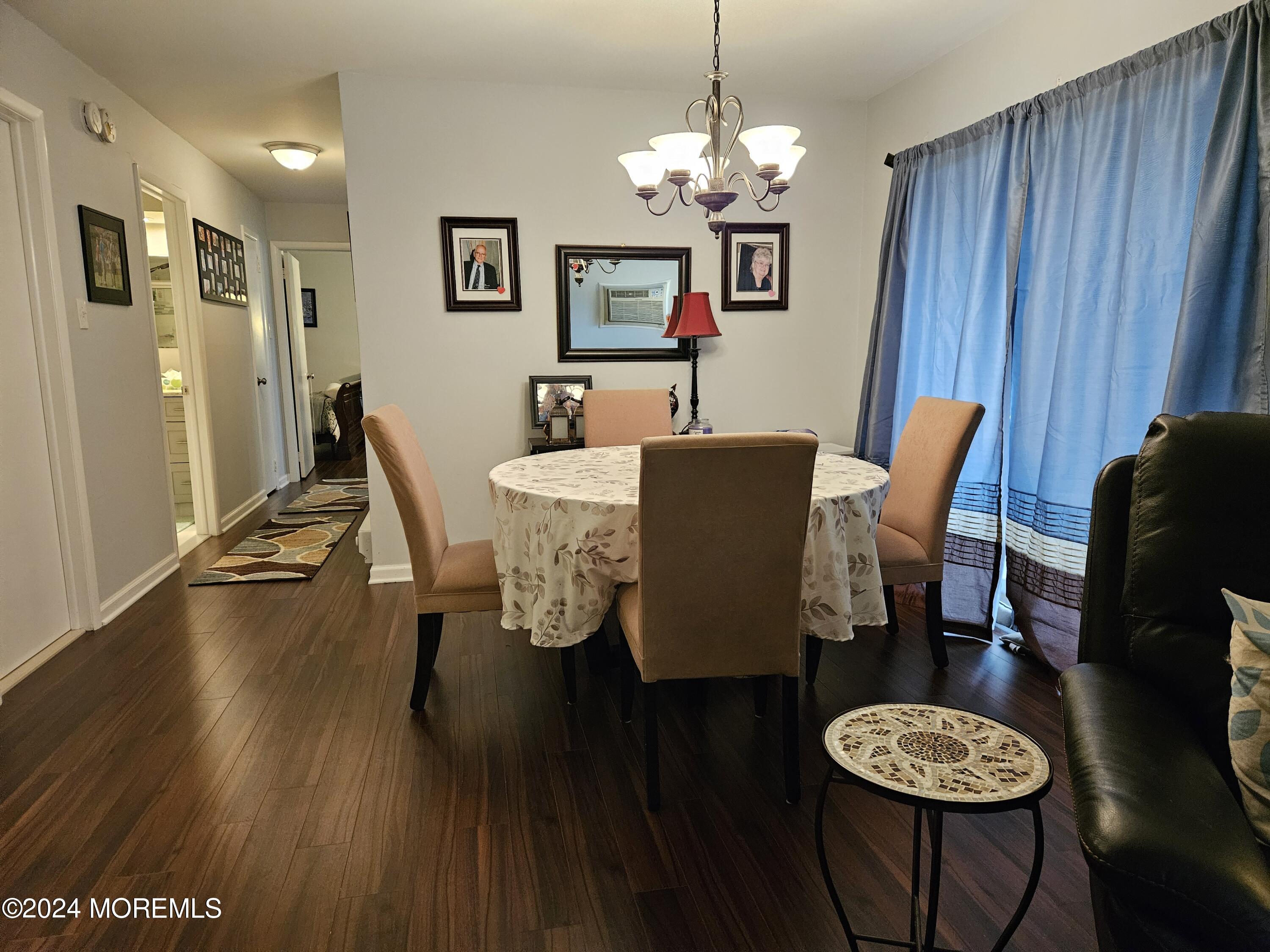 75 Overlook Way, Unit E Manalapan, NJ 07726 - Photo 7 of 12 a view of a dining room with furniture and wooden floor