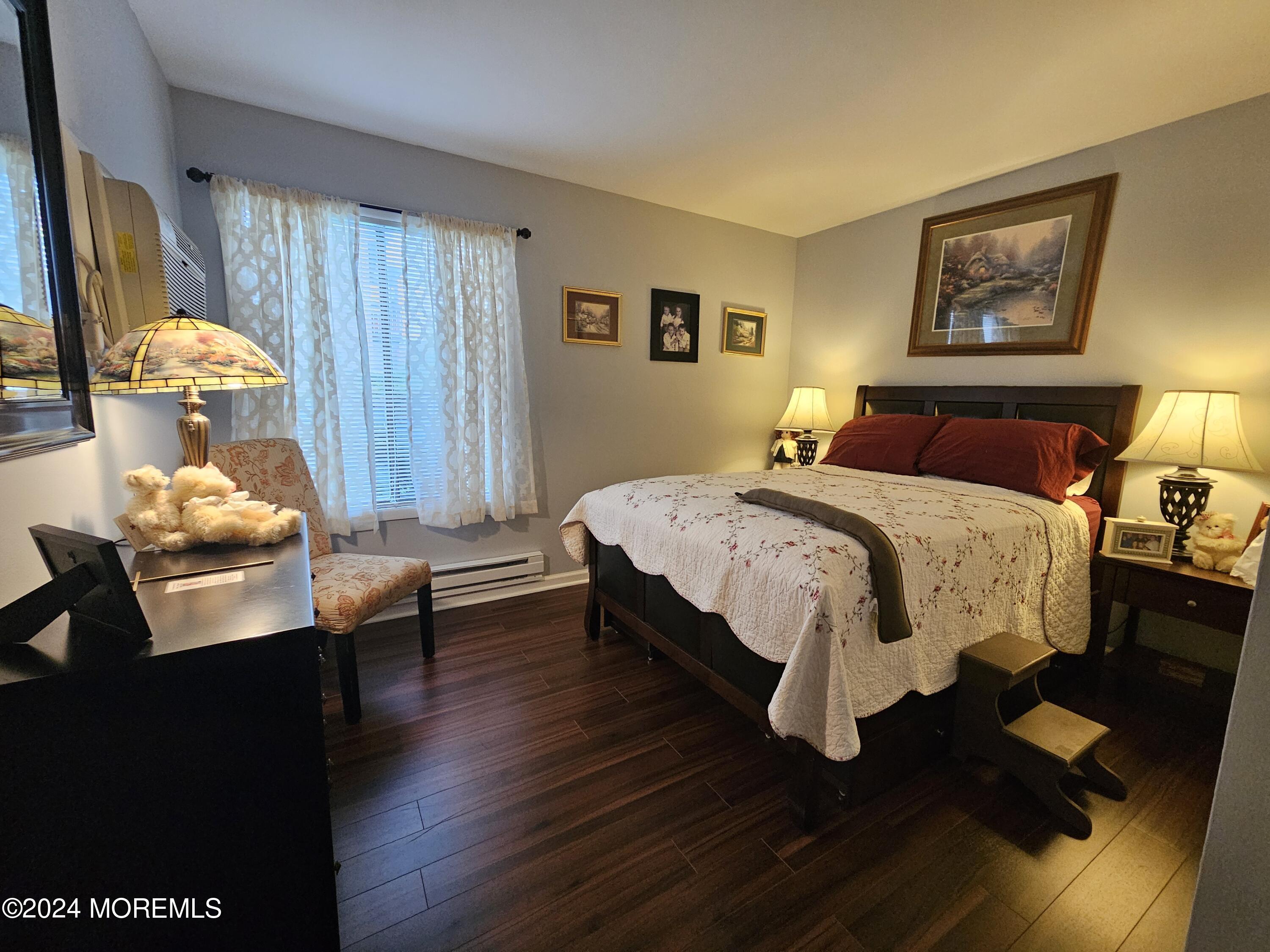 75 Overlook Way, Unit E Manalapan, NJ 07726 - Photo 8 of 12 a bedroom with a bed table and a window