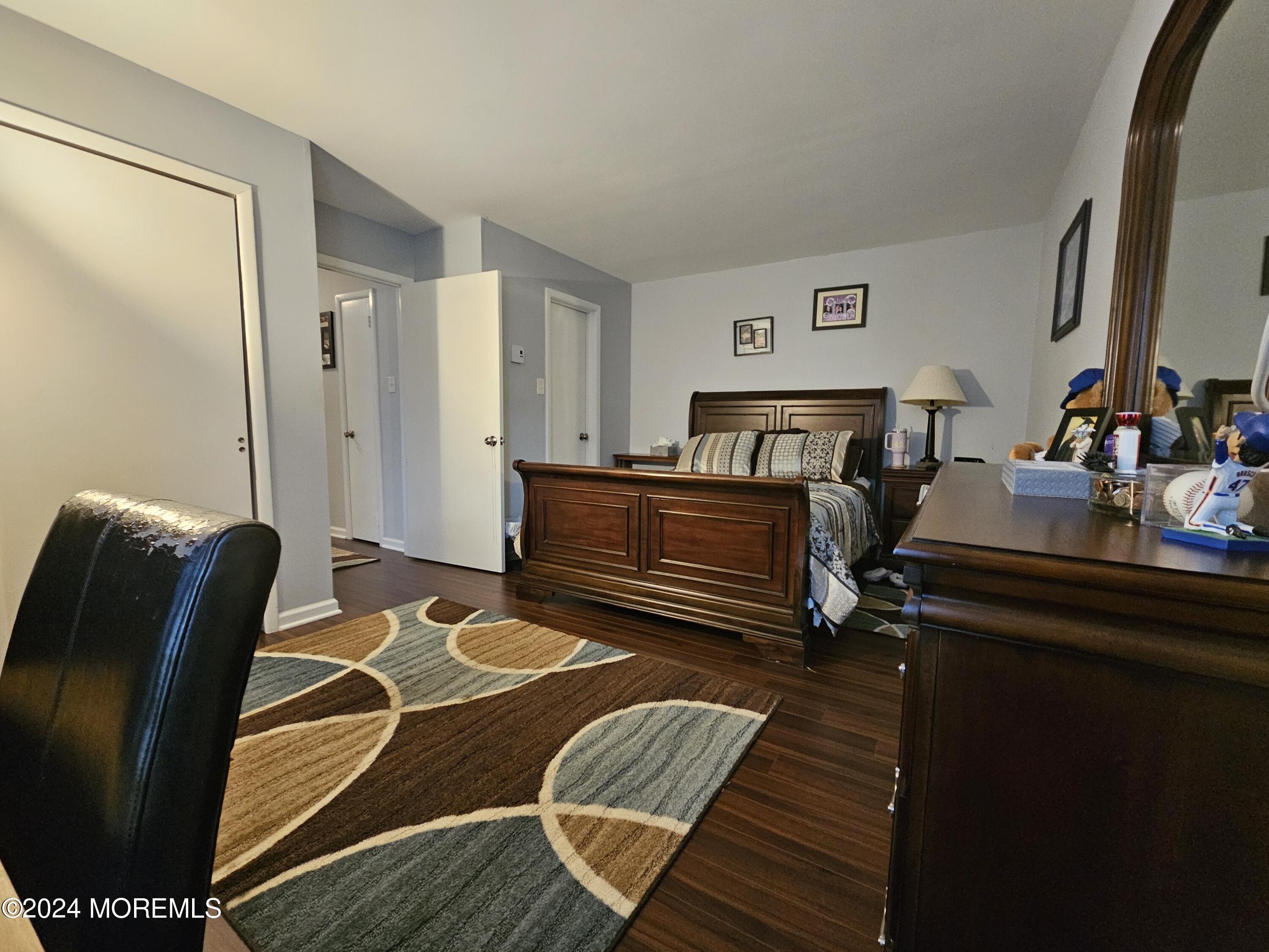 75 Overlook Way, Unit E Manalapan, NJ 07726 - Photo 9 of 12 a bedroom with a bed and wooden floor