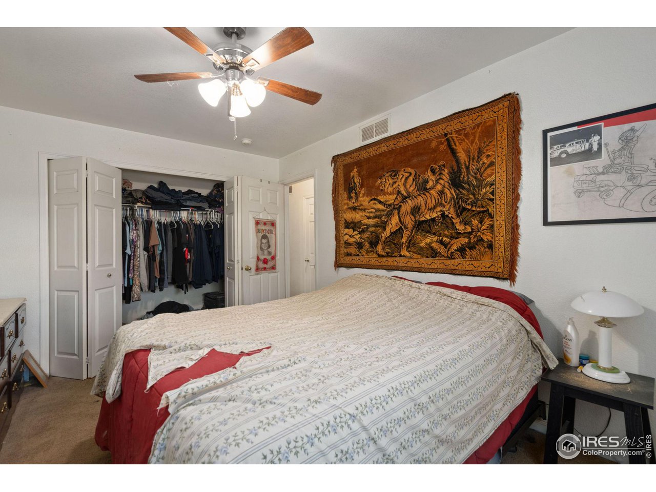 213 East 21st Street Road Greeley, CO 80631 - Photo 10 of 18 a bedroom with a bed and a painting on the wall