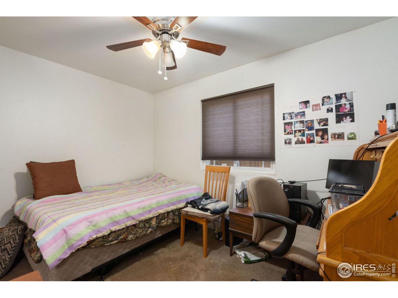 213 East 21st Street Road Greeley, CO 80631 - Photo 12 of 18 a bedroom with a bed work place and a desk