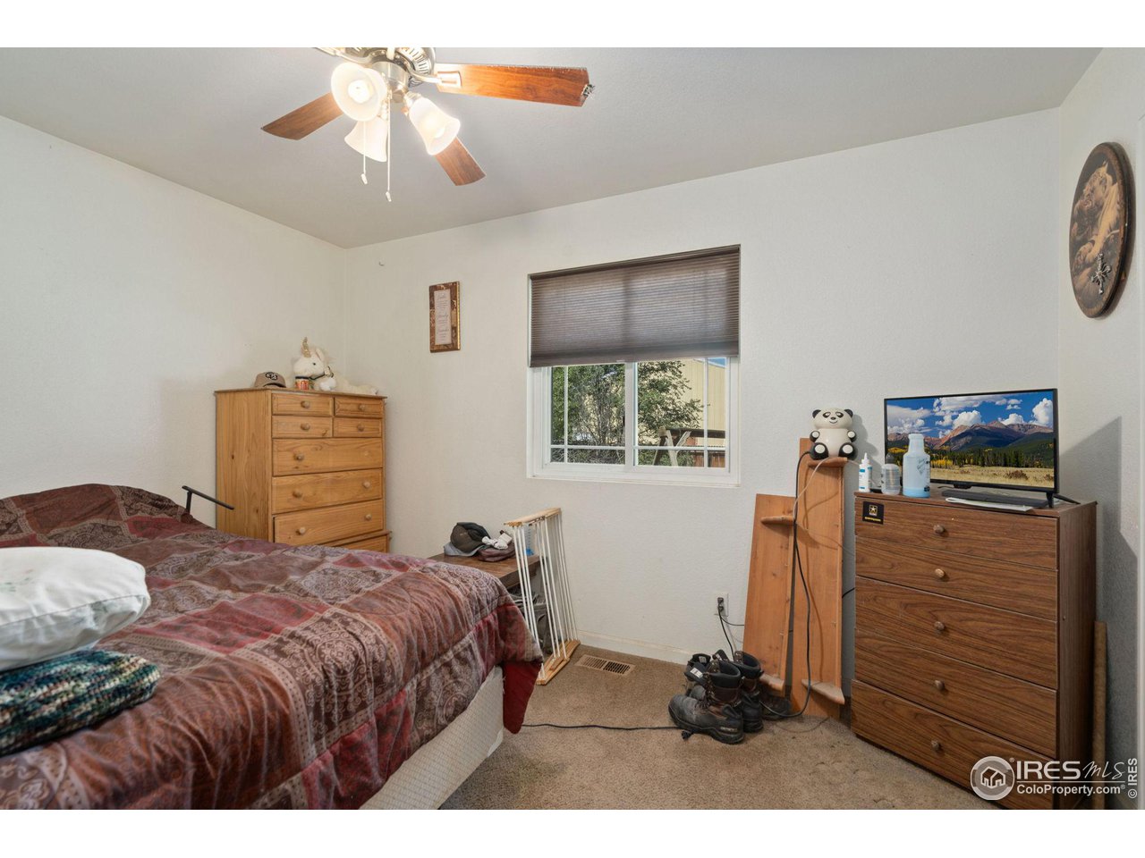 213 East 21st Street Road Greeley, CO 80631 - Photo 13 of 18 a bedroom with a bed and a chandelier