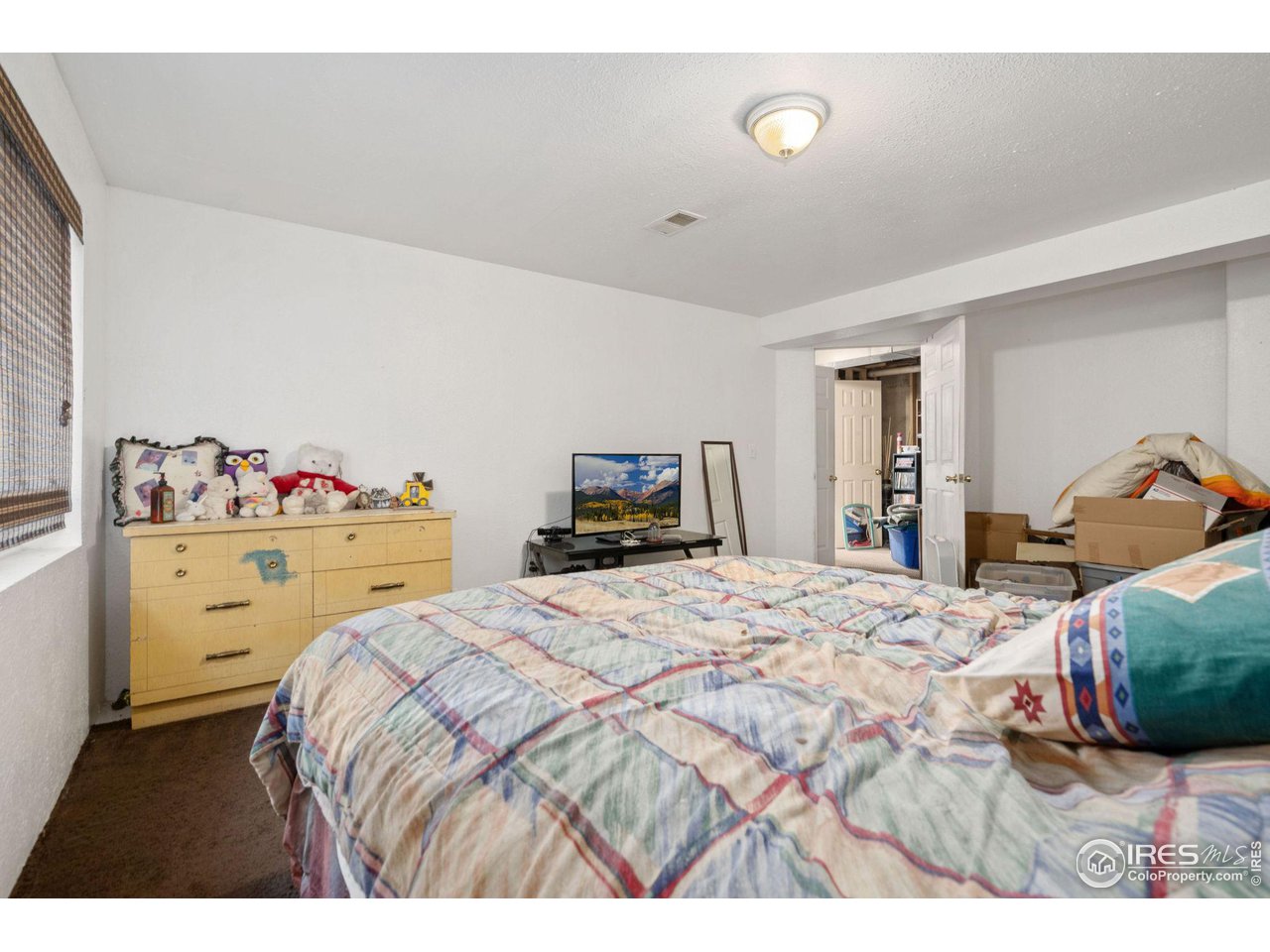 213 East 21st Street Road Greeley, CO 80631 - Photo 16 of 18 a bedroom with a bed and a closet
