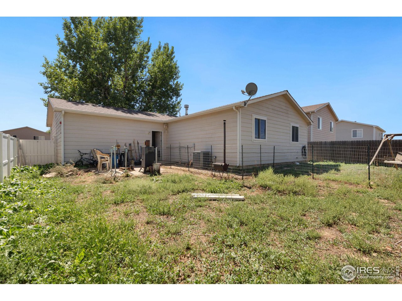 213 East 21st Street Road Greeley, CO 80631 - Photo 17 of 18 a front view of a house with a yard