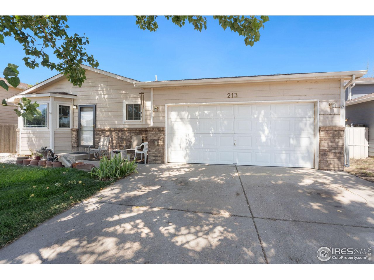 213 East 21st Street Road Greeley, CO 80631 - Photo 2 of 18 a front view of a house with garden