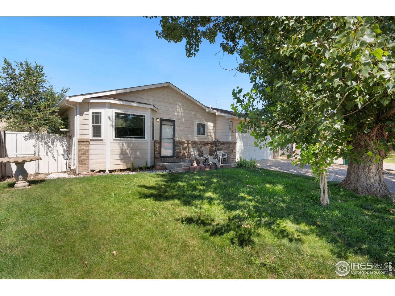 213 East 21st Street Road Greeley, CO 80631 - Photo 3 of 18 a front view of house with yard and green space