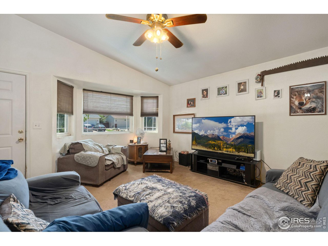 213 East 21st Street Road Greeley, CO 80631 - Photo 4 of 18 a living room with furniture and a flat screen tv