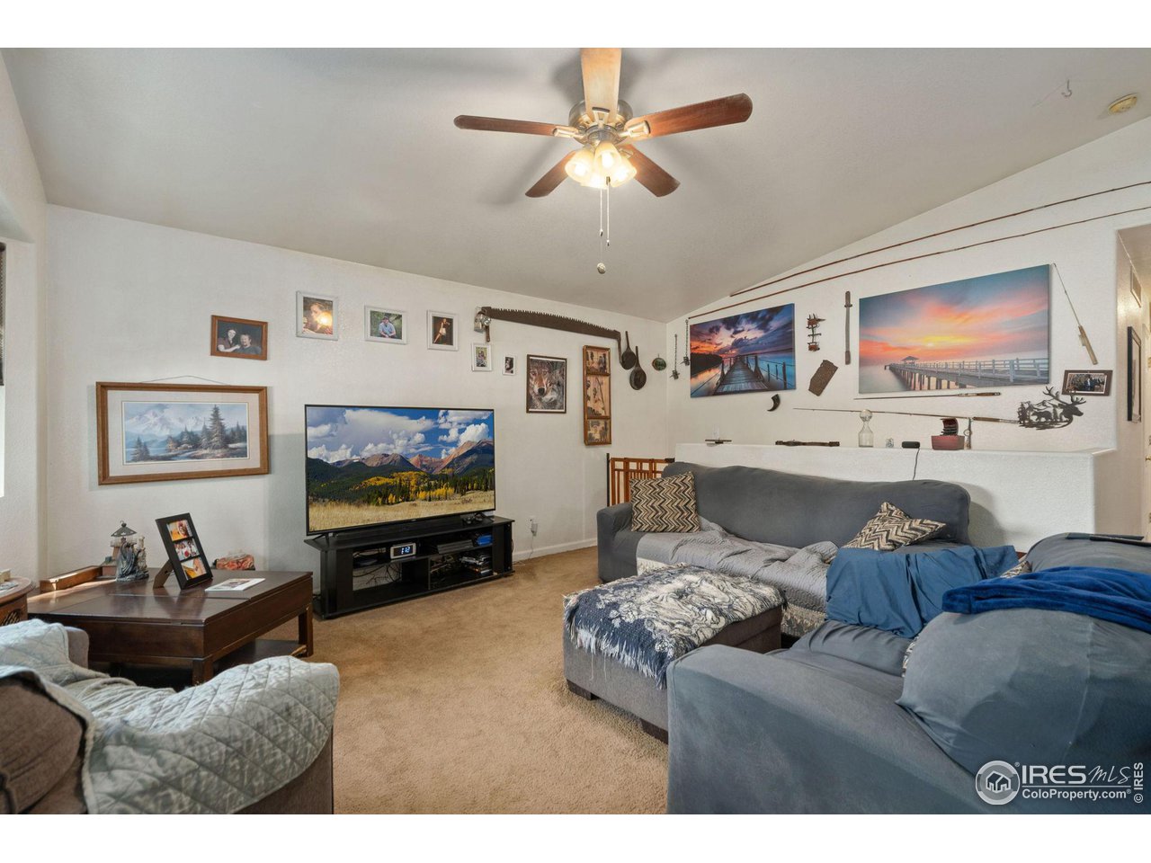 213 East 21st Street Road Greeley, CO 80631 - Photo 5 of 18 a living room with furniture and a flat screen tv