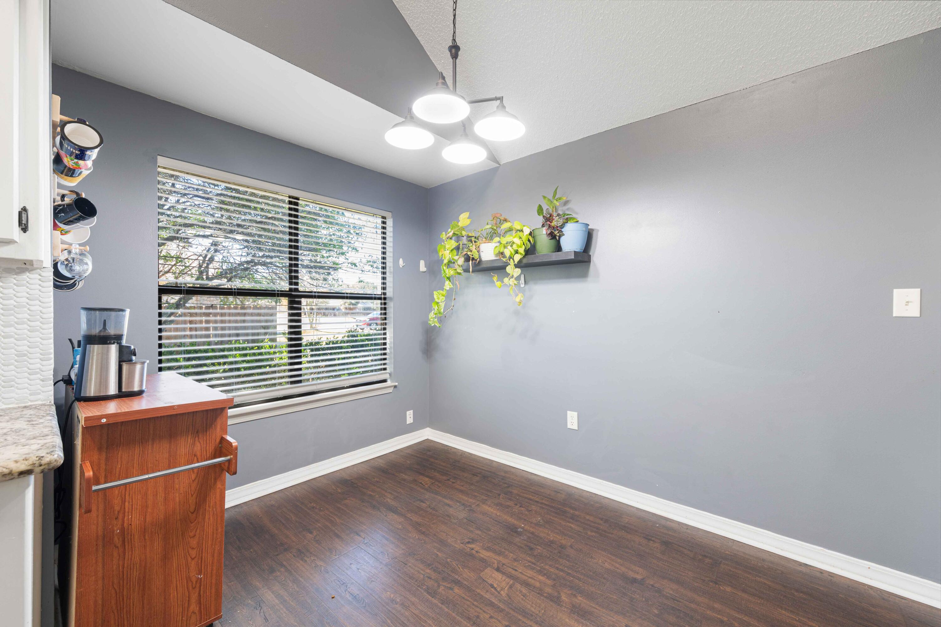 1920 Seahawk Lane Navarre, FL 32566 - Photo 13 of 30 an empty room with wooden floor and windows