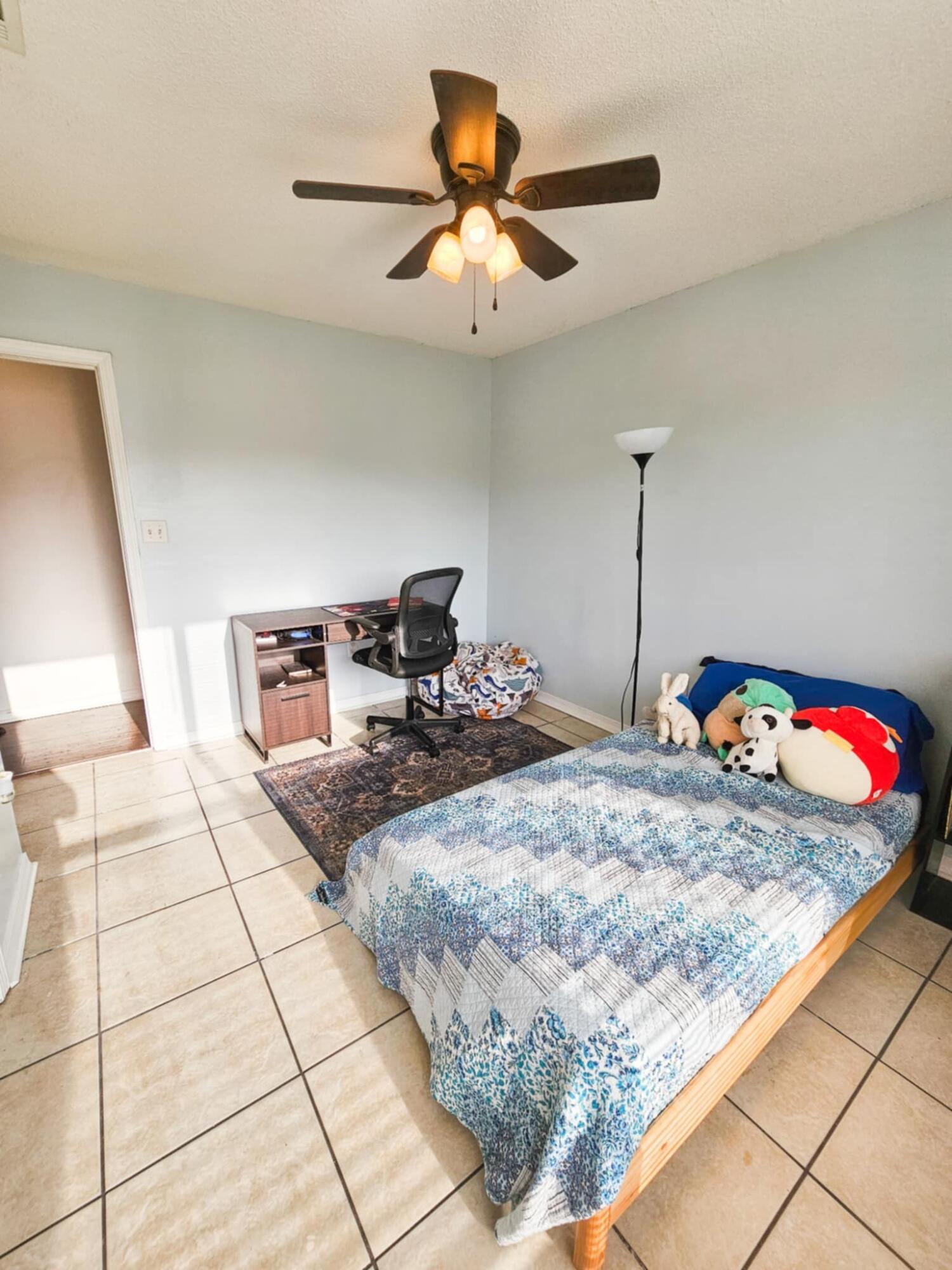 1920 Seahawk Lane Navarre, FL 32566 - Photo 15 of 30 a bedroom with a bed and a chandelier