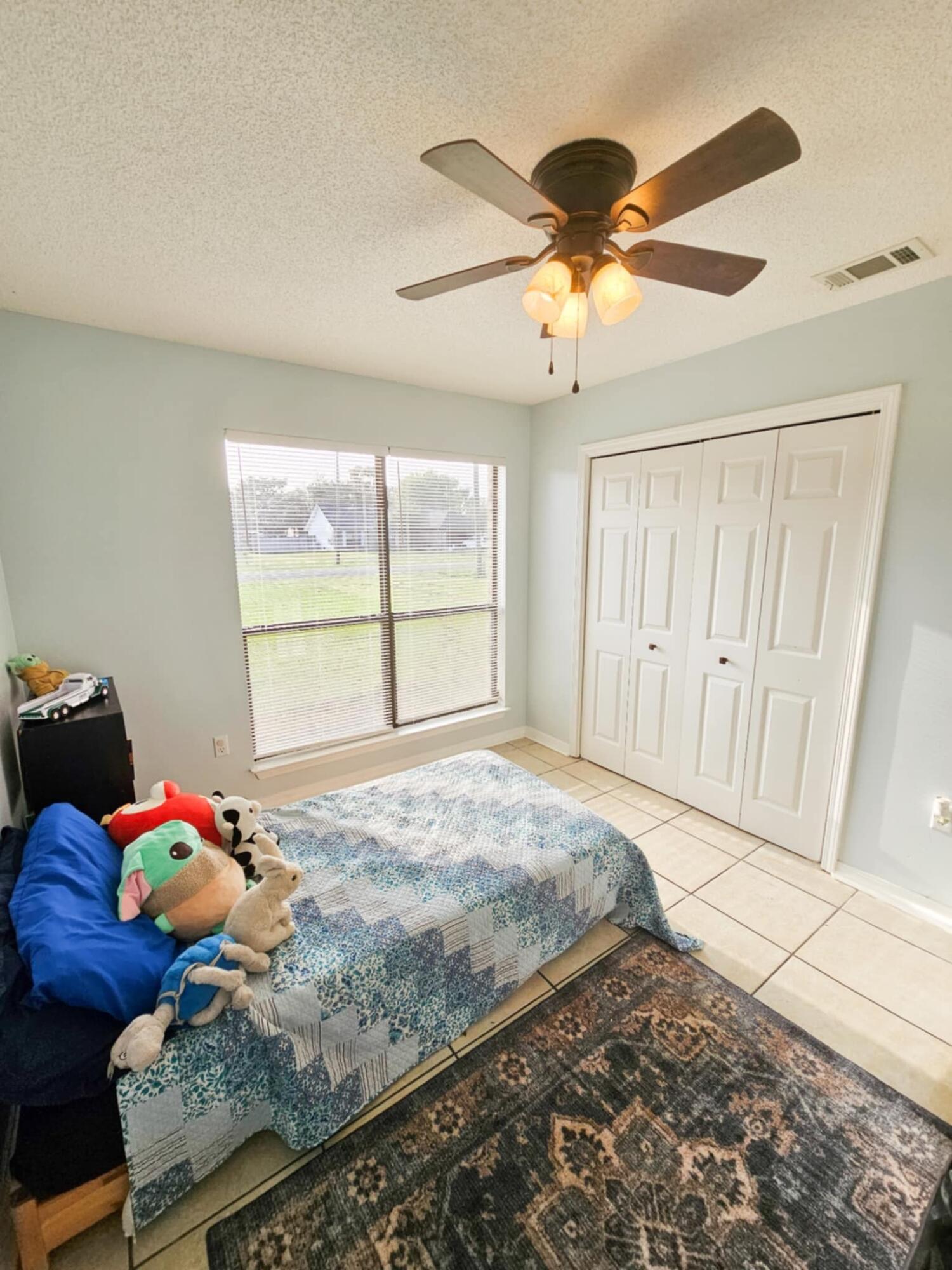 1920 Seahawk Lane Navarre, FL 32566 - Photo 16 of 30 a bedroom with a bed and a window