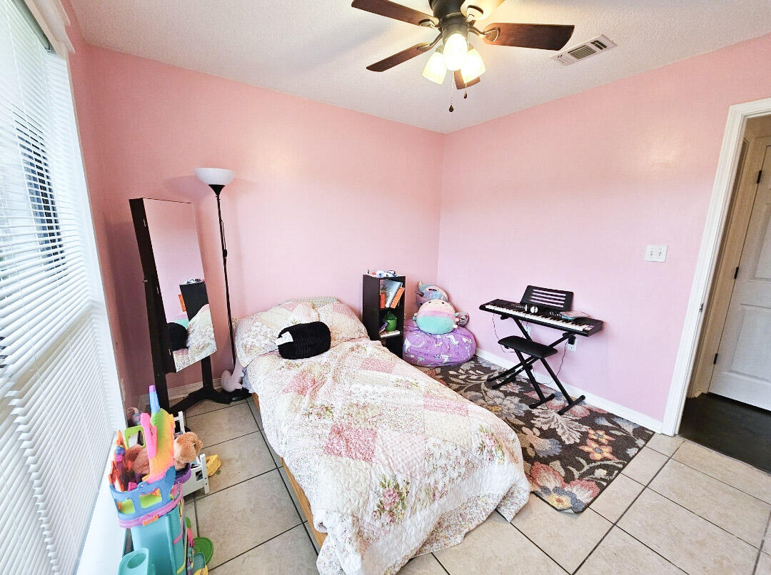 1920 Seahawk Lane Navarre, FL 32566 - Photo 19 of 30 a bedroom with furniture and a wooden floor