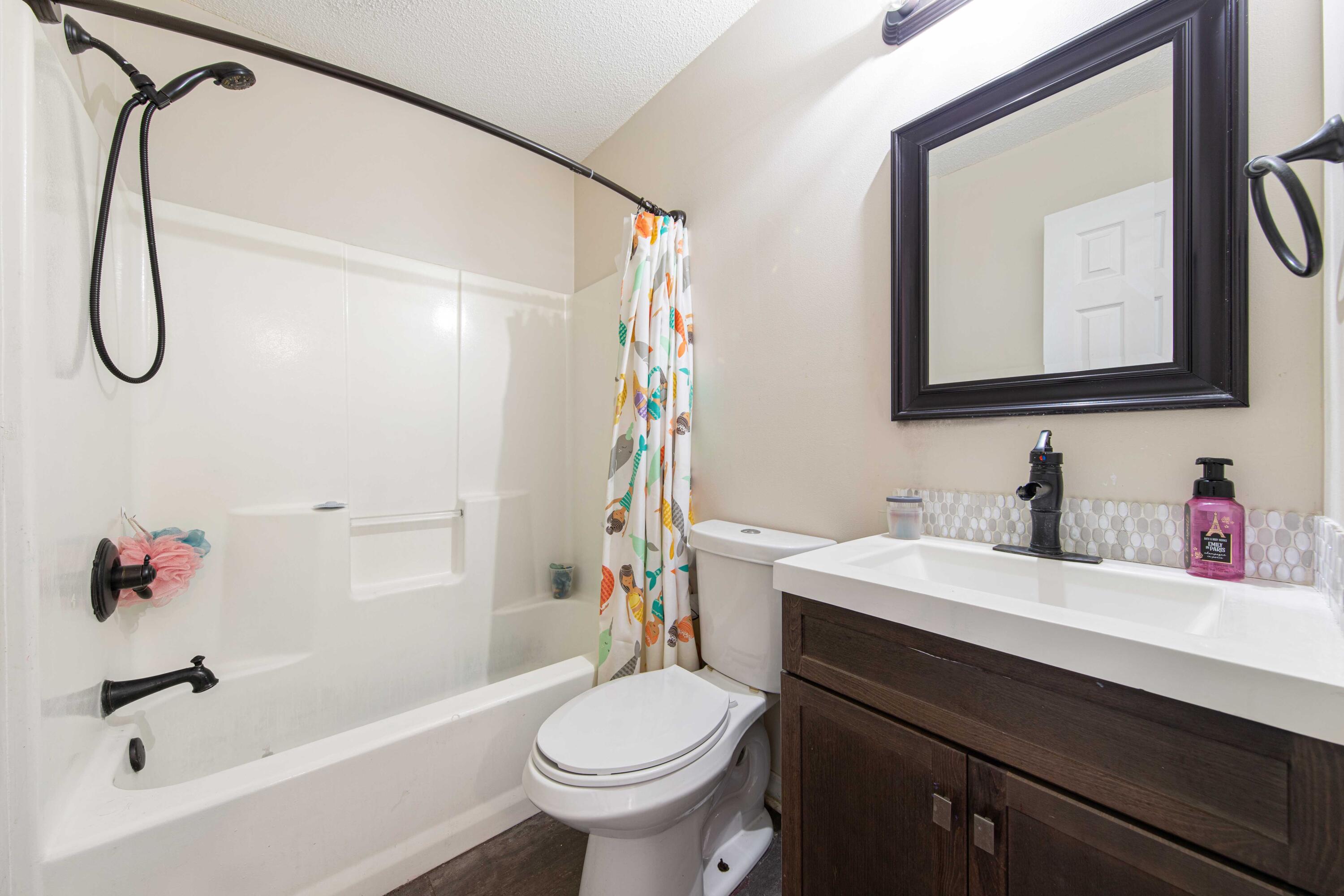 1920 Seahawk Lane Navarre, FL 32566 - Photo 20 of 30 a bathroom with a sink vanity mirror and toilet