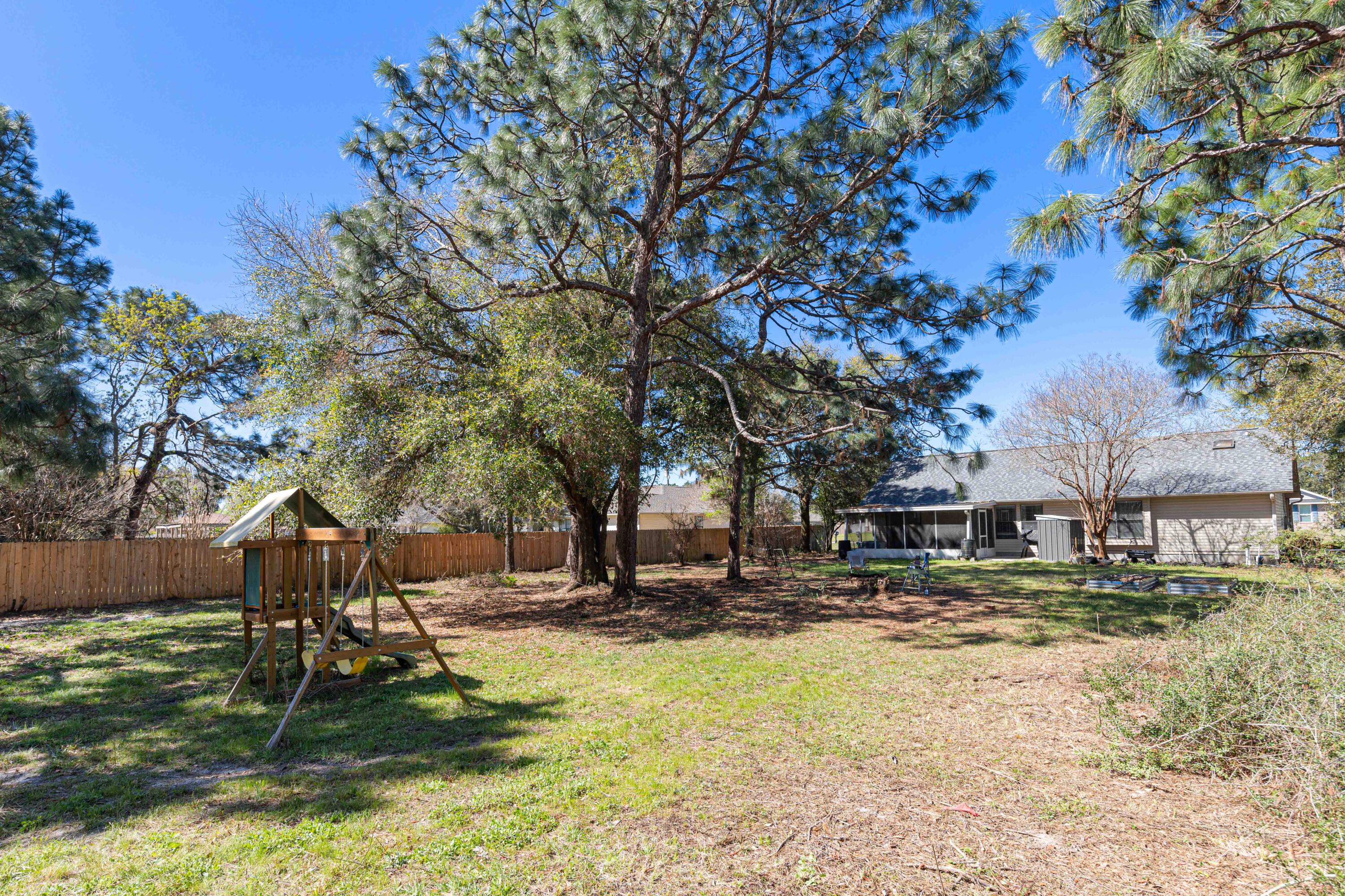 1920 Seahawk Lane Navarre, FL 32566 - Photo 28 of 30 a backyard of a house with table and chairs