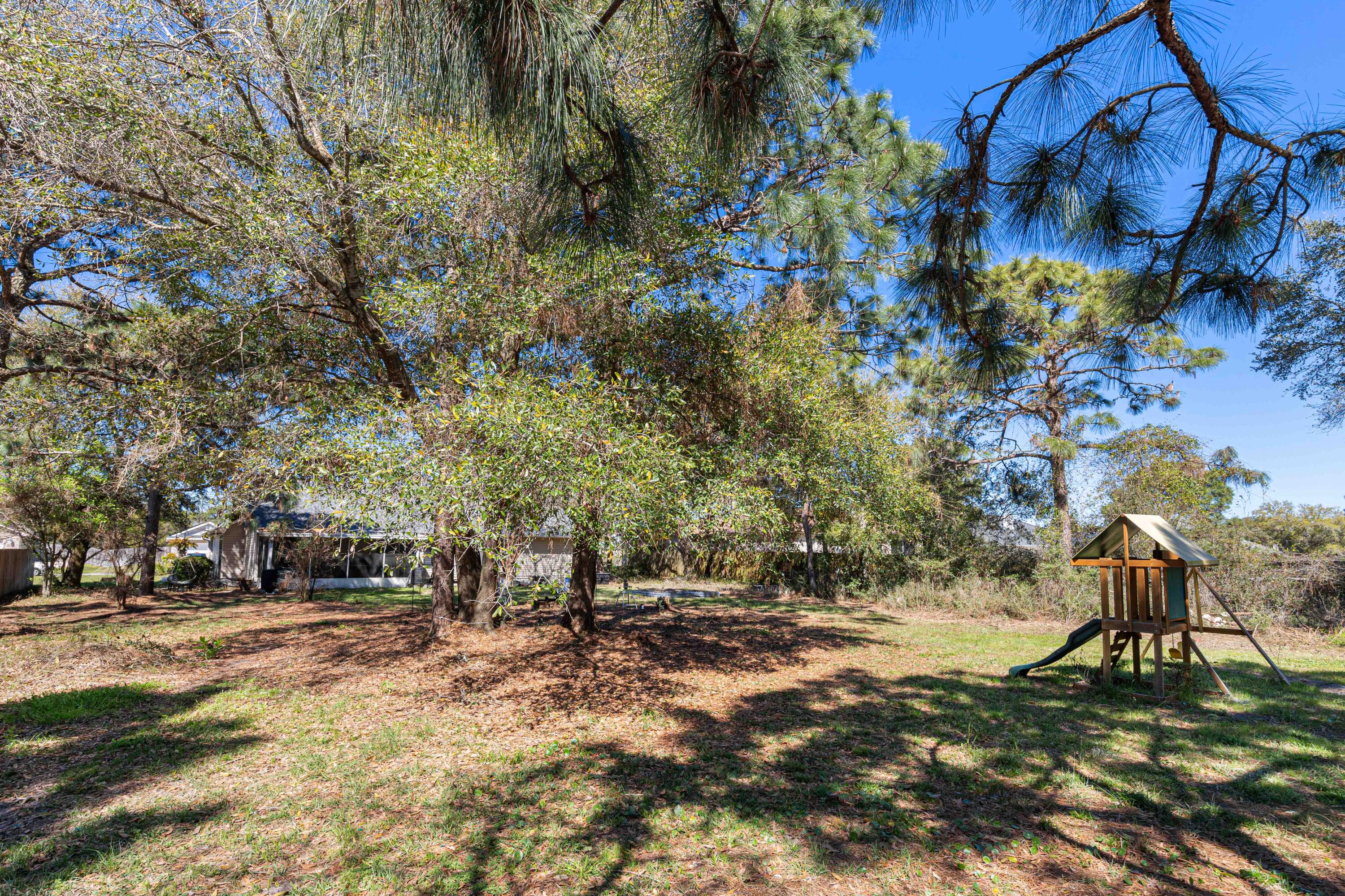 1920 Seahawk Lane Navarre, FL 32566 - Photo 29 of 30 a backyard of a house with lots of green space