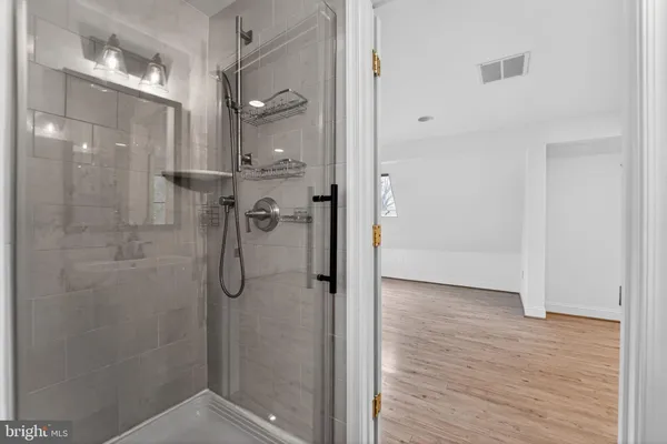 a bathroom with a glass shower door