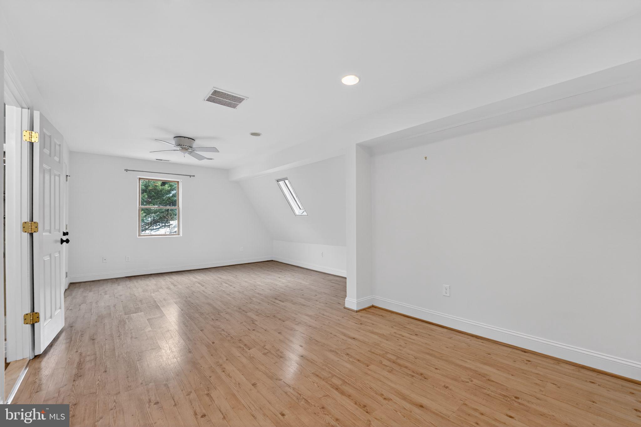 3511 Decatur Avenue Kensington, MD 20895 - Photo 29 of 35 an empty room with wooden floor and windows