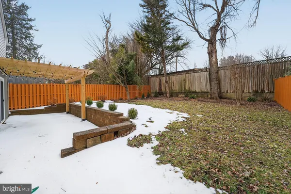 a view of a backyard with wooden fence