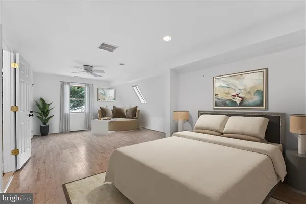 a bedroom with a large bed and a couch