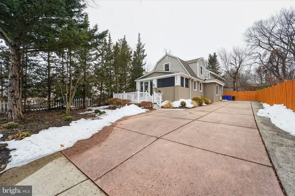 a view of a white house with a yard
