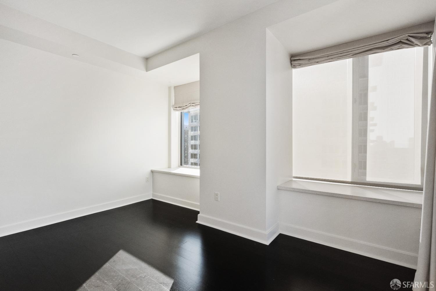 188 Minna, Unit 33A San Francisco, CA 94105 - Photo 21 of 29 an empty room with wooden floor and windows