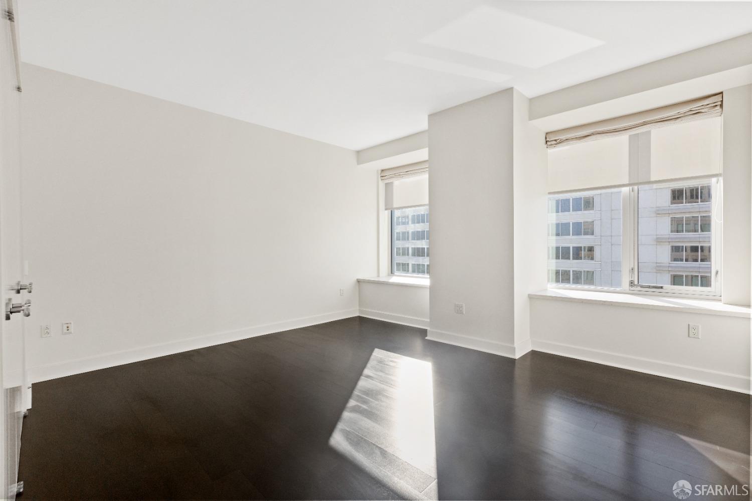 188 Minna, Unit 33A San Francisco, CA 94105 - Photo 25 of 29 an empty room with wooden floor and windows
