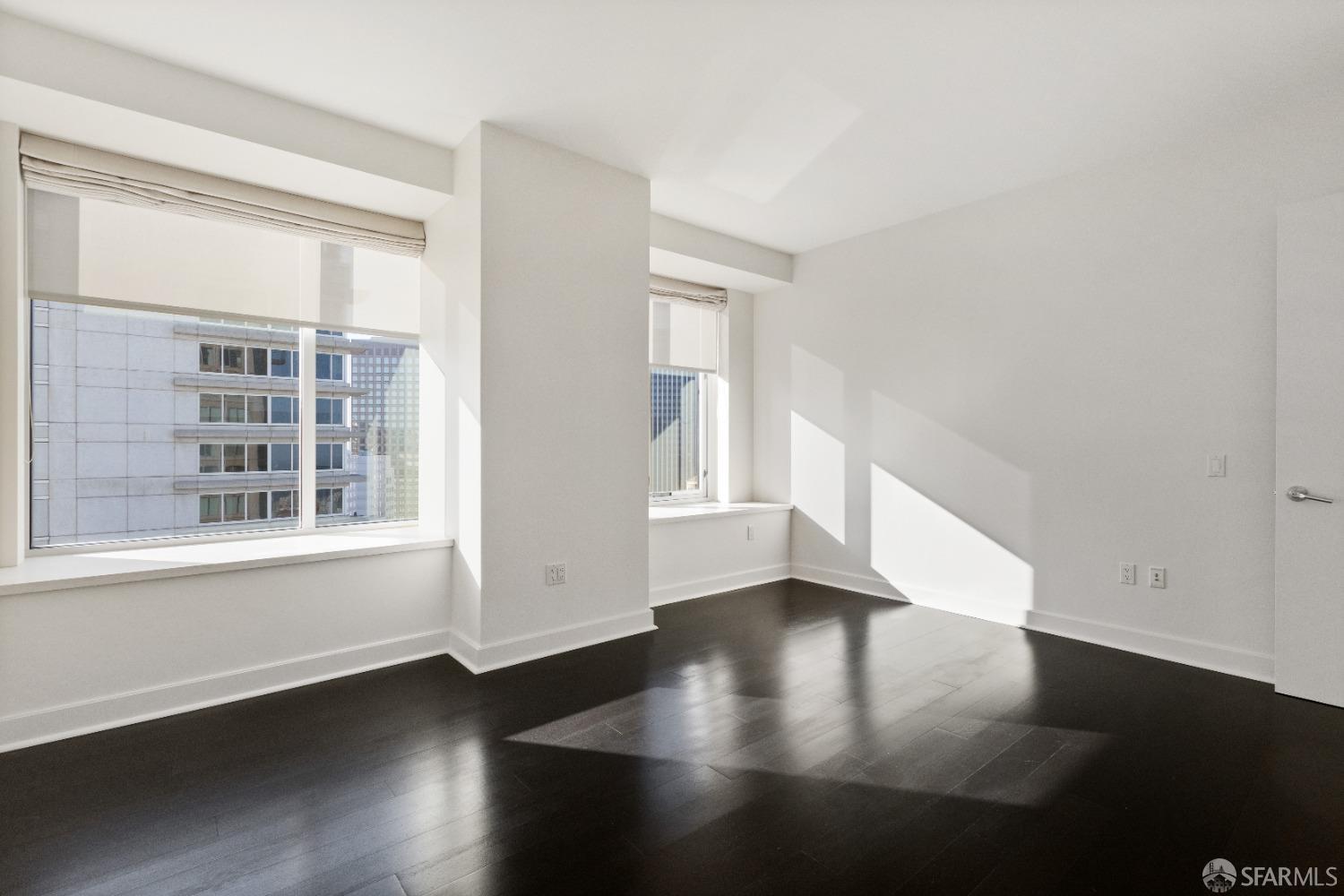 188 Minna, Unit 33A San Francisco, CA 94105 - Photo 26 of 29 a view of an empty room with wooden floor and a window
