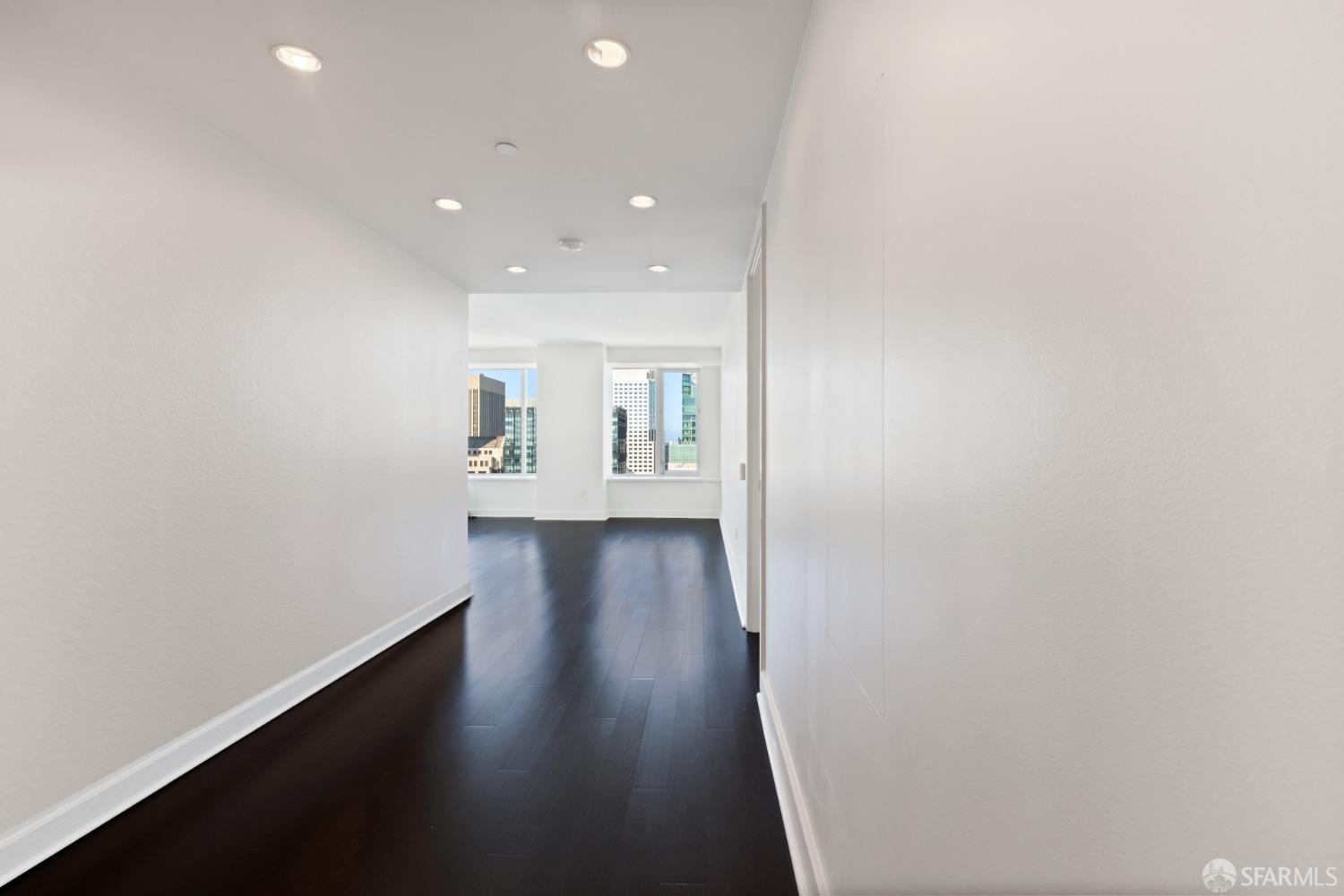 188 Minna, Unit 33A San Francisco, CA 94105 - Photo 7 of 29 an empty room with wooden floor and windows