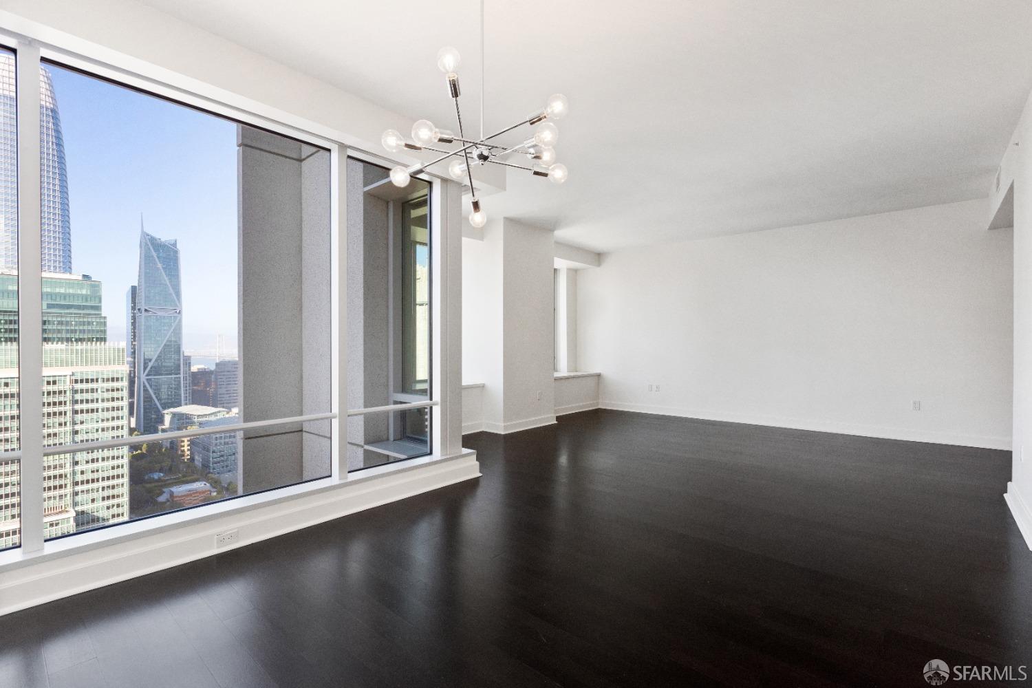 188 Minna, Unit 33A San Francisco, CA 94105 - Photo 8 of 29 an empty room with wooden floor and windows
