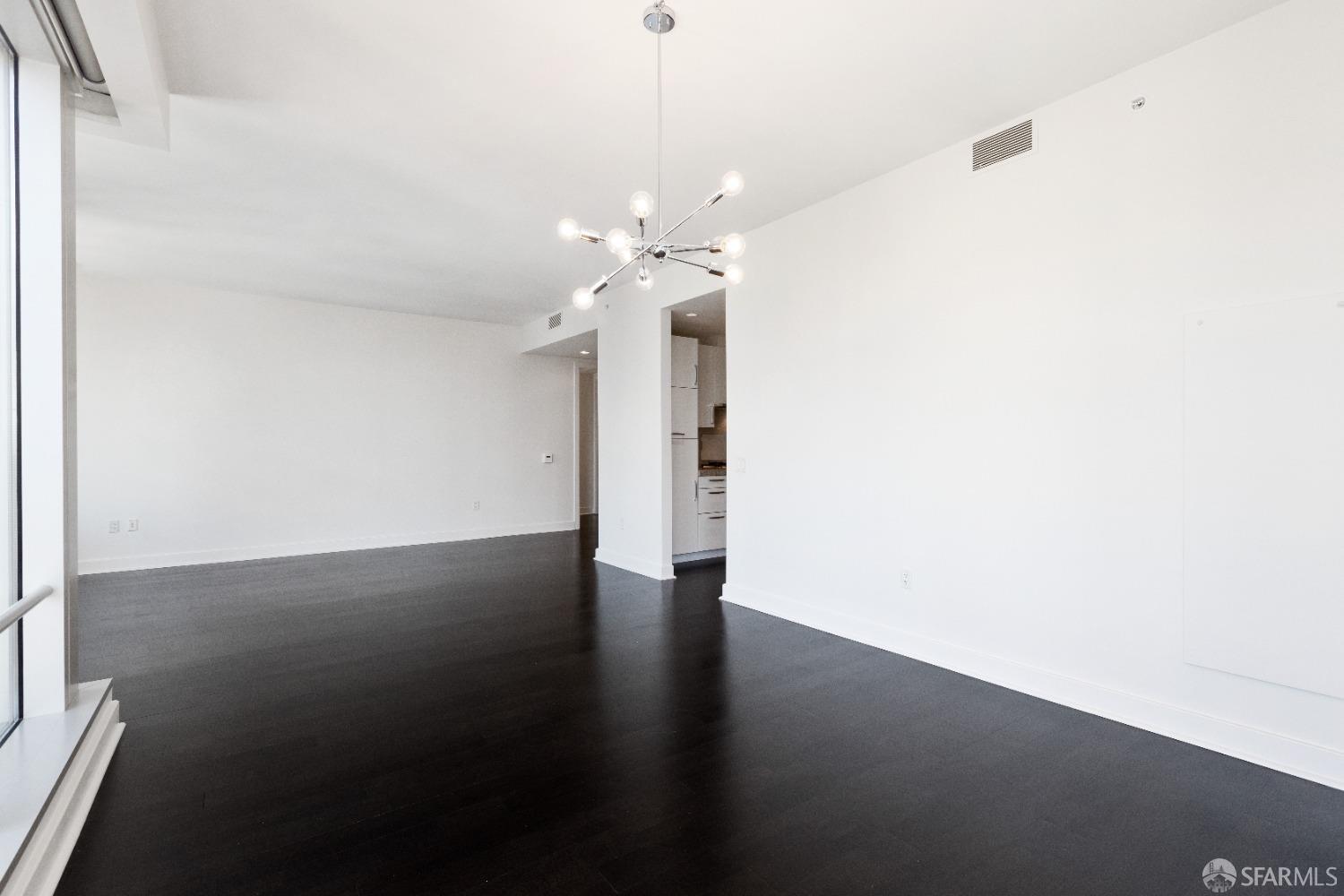 188 Minna, Unit 33A San Francisco, CA 94105 - Photo 9 of 29 a view of a room with a chandelier fan and wooden floor