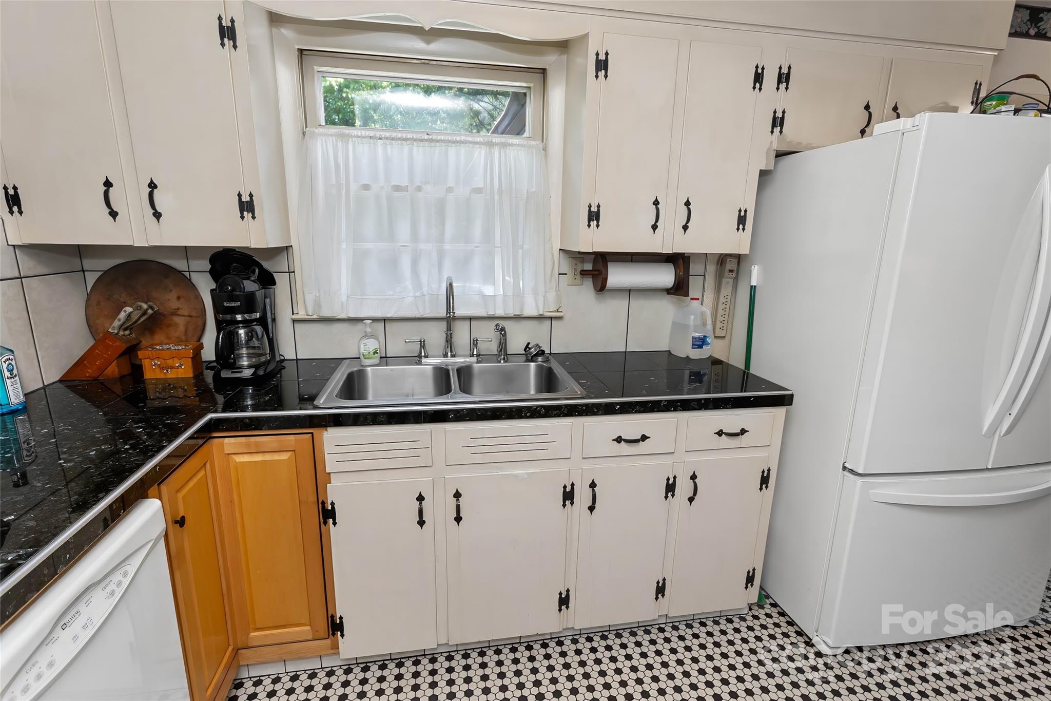 45 Cub Road Asheville, NC 28806 - Photo 11 of 46 a kitchen with granite countertop a refrigerator a sink a stove and white cabinets