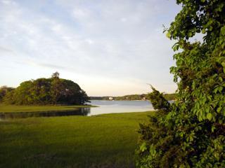 68 Bayview Road Mashpee, MA 02649 - Photo 3 of 10 a view of a lake with a big yard