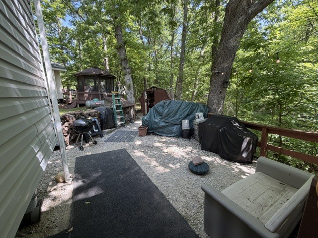 2795 East 28th Road Marseilles, IL 61341 - Photo 24 of 63 a view of a patio with table and chairs with wooden floor and fence