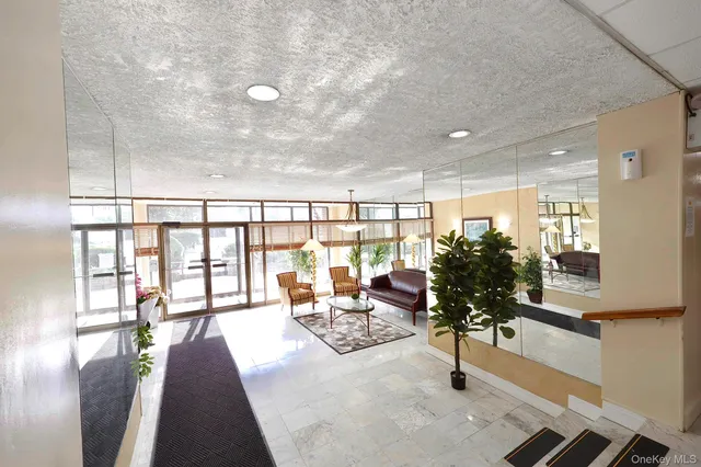 a lobby with furniture and floor to ceiling window