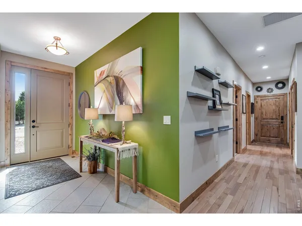 a kitchen with granite countertop a stove a sink dishwasher and a refrigerator with wooden floor