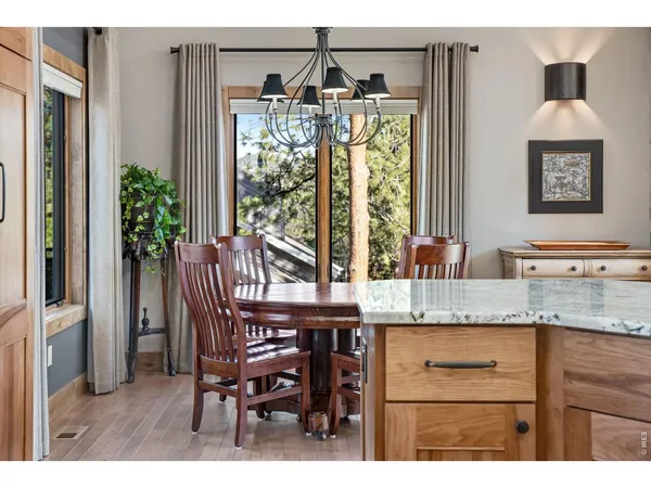 a view of a dining room with furniture wooden floor and chandelier