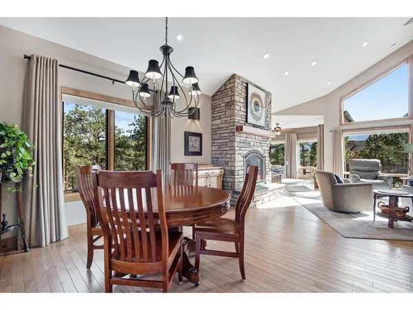 a living room with furniture a large window and a fireplace