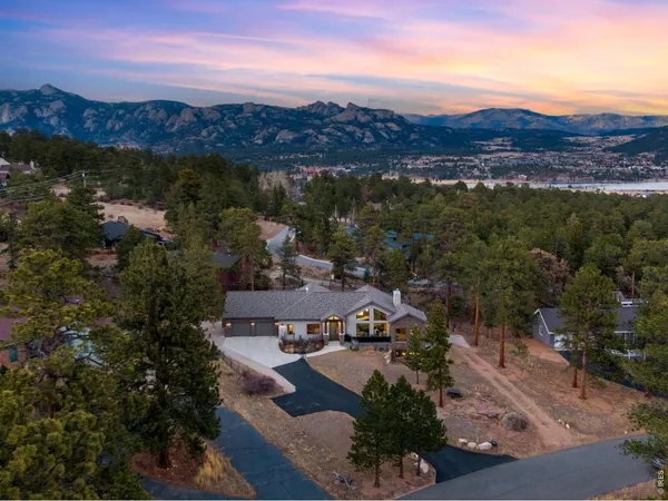 a view of a house with backyard and a sitting area