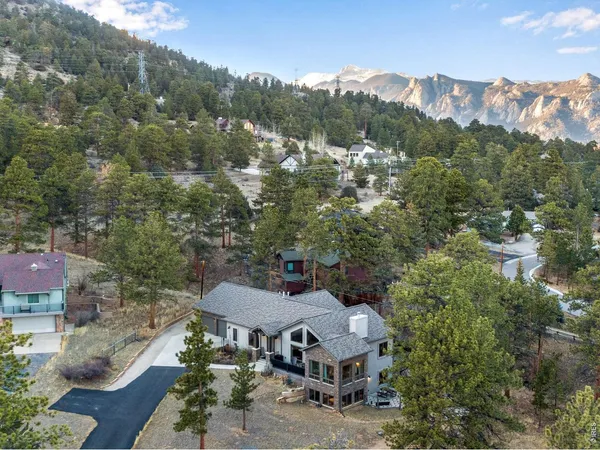 an aerial view of a house with mountain view