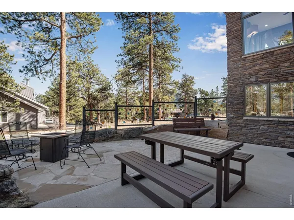 a roof deck with outdoor seating and city view