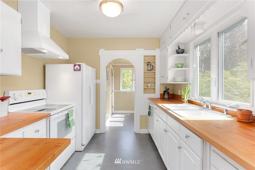 3926 Midvale Avenue North Seattle, WA 98103 - Photo 10 of 25 a spacious bathroom with a granite countertop sink and a window