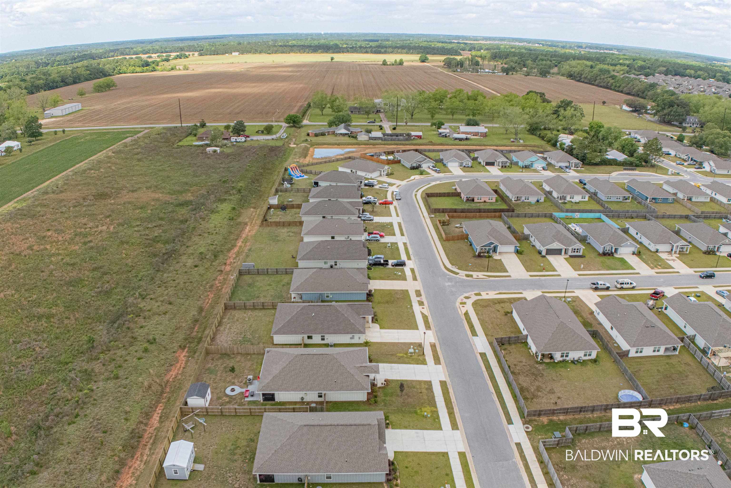 14843 Forsythia Loop Silverhill, AL 36576 - Photo 50 of 51 Aerial view of property and surrounding area featuring extensive farmland, rural landscape, and nearby suburban area