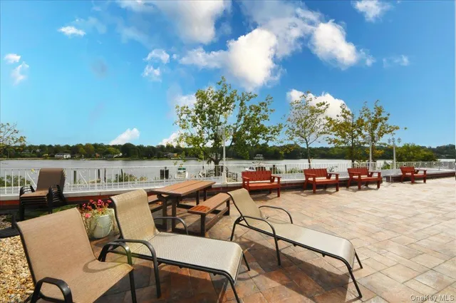 a view of a lake with couches chairs