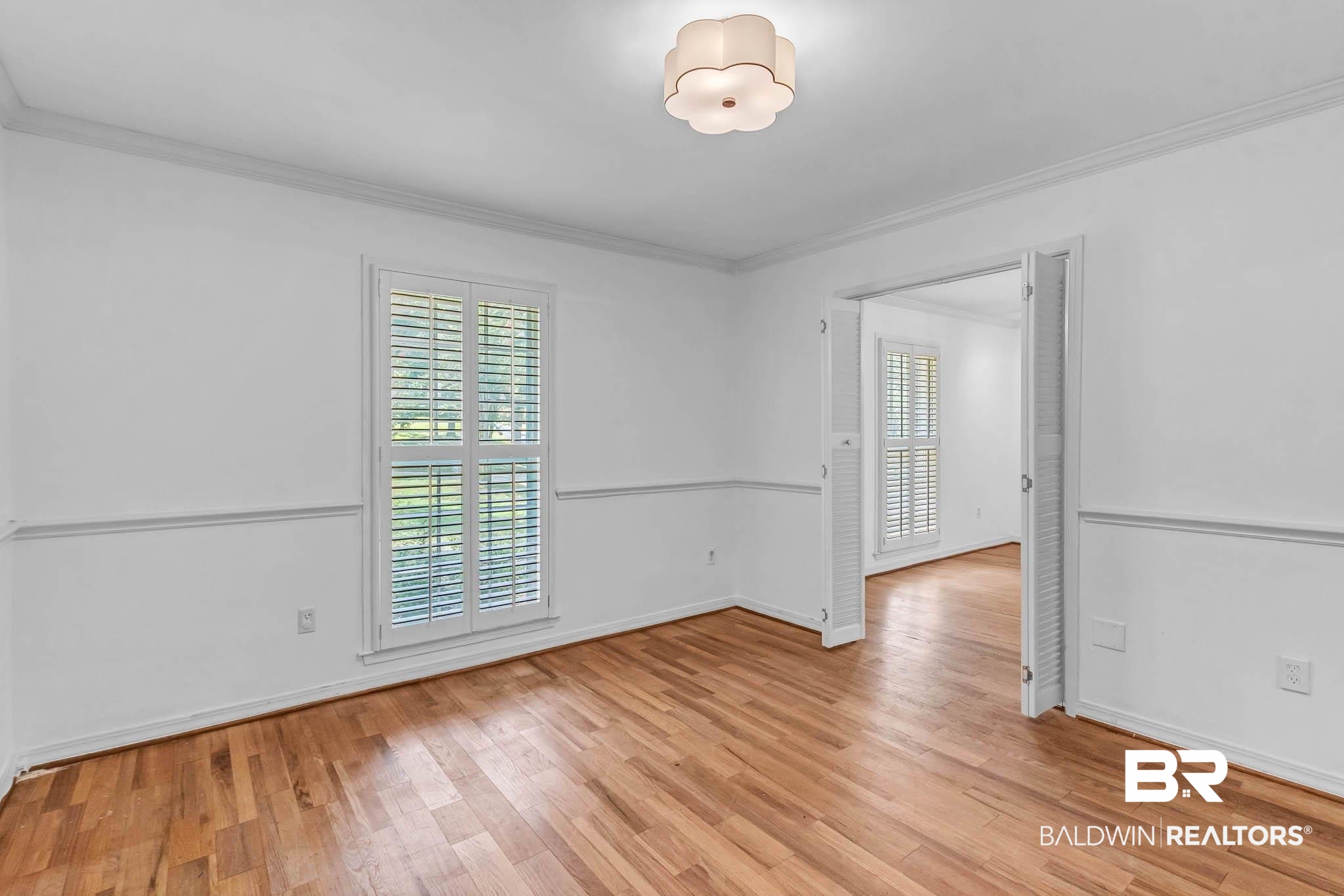 309 West Brandy Run Road Mobile, AL 36608 - Photo 33 of 100 Empty room with healthy amount of natural light, ornamental molding, and light wood finished floors
