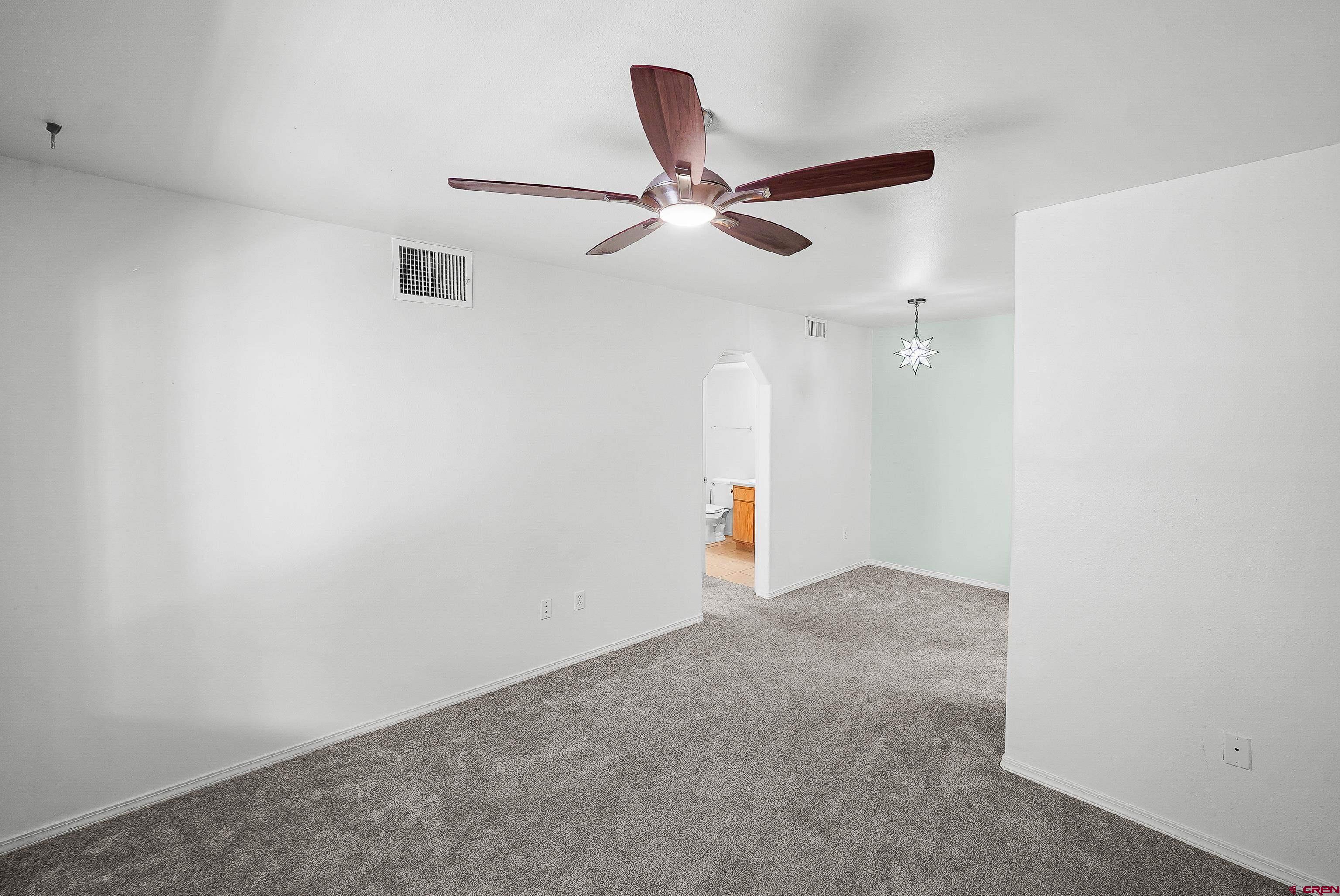 1100 Goeglein Gulch Road, Unit 163 Durango, CO 81301 - Photo 8 of 23 an empty room with ceiling fan and window